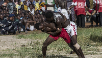 Two men engaged in a local wrestling