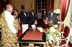 Otumfuo signing the visitor