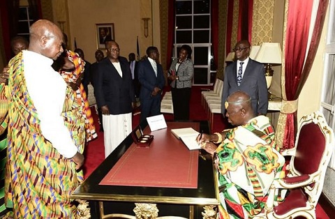 Otumfuo signing the visitor