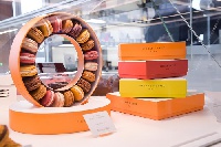 Guests can use miles or credit cards to purchase macarons and chocolates at JFK Delta Sky Club