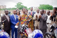 Dr Kwabena Duffuor, Chairman of the Welfare Committee, cutting the ribbon to handover the motorbikes