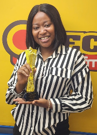 OTEC FM’s news anchor, Maame Adwoa Nyanta Tando with her award