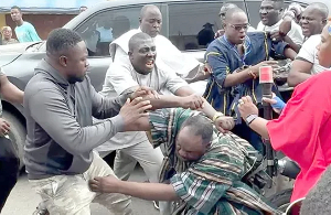 Deputy National Organiser of the NPP [in smock] being assaulted by some thugs