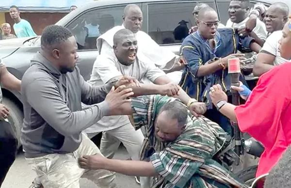 Deputy National Organiser of the NPP [in smock] being assaulted by some thugs