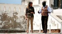 Melania Trump at the Cape Coast Castle, aided by a tour guide