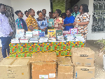 Prof Jerry John presenting the books to the team at the Univ of Ghana School of Nursing