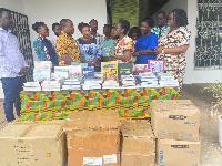 Prof Jerry John presenting the books to the team at the Univ of Ghana School of Nursing