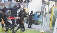 Referee Ernest Baafi had to be shielded