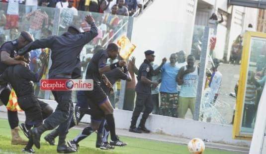 Referee Ernest Baafi had to be shielded