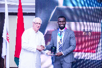 Father Campbell presenting an award to Joe Benny Frempong of Sewia Mining