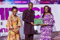 Minister of Communications, Mrs. Ursula Owusu-Ekuful receiving an award at  FEMITECH Conference
