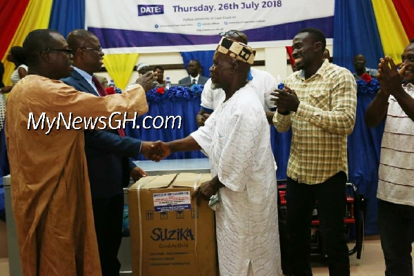 UCC VC, Prof Joseph Ghartey Ampiah presenting deep freezer to Kwaku Essoun, longest serving staff