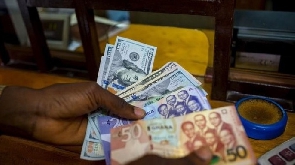 Ghana Cedi notes and US dollar bills | File photo