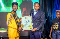 Ghanaian musician, TiC receiving the award