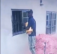 The suspect captured removing the glass window
