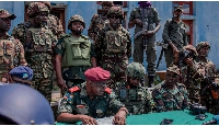 East African Regional Force officers meet with M23 rebels during the handover ceremony