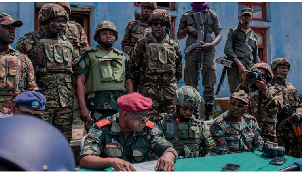 East African Regional Force officers meet with M23 rebels during the handover ceremony