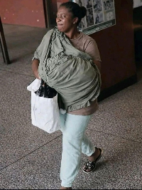 The picture appears to show a woman carrying what many describe as a sack