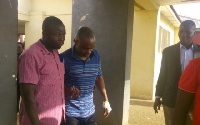Obengfo in blue attire being assisted out of the courtroom