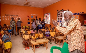 Professor Emeritus Stephen Adei with some school children