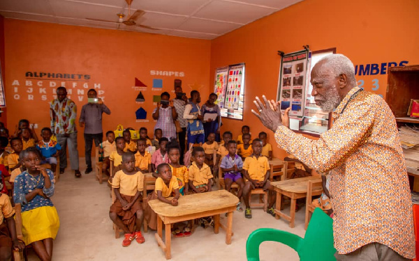 Professor Emeritus Stephen Adei with some school children