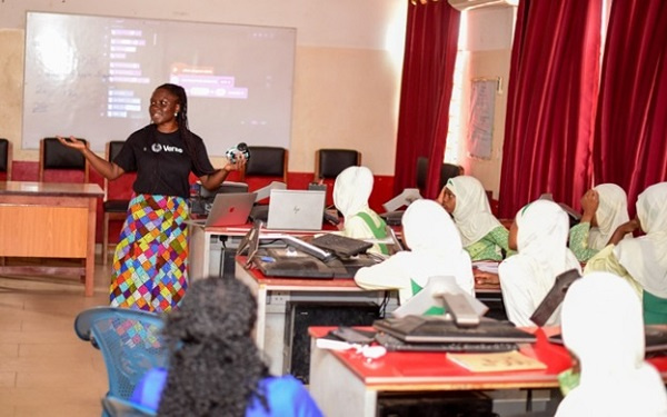 Asiedua Addae, Head of Corporate Affairs, Brand & Marketing speaking to some students