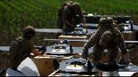 Service members with the Unmanned Systems Forces prepare mid-range strike drones for a launch