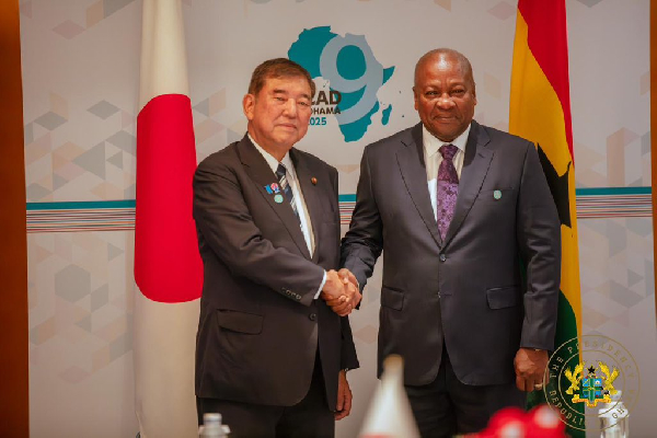 Japanese Prime Minister Shigeru Ishiba in a handshake with President Mahama