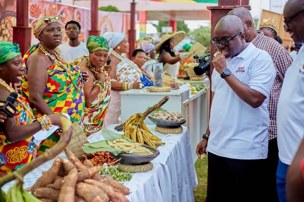 CEO of Ghana Tourism Authority,  Akwasi Agyemang checking some dishes out