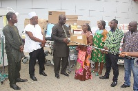 Mr. Maxwell Blagogee receiving the items from Mrs. Akosua Newman of the Rebecca Foundation