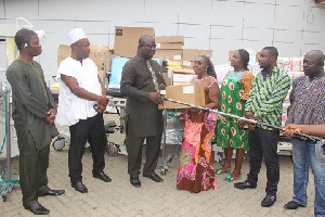 Mr. Maxwell Blagogee receiving the items from Mrs. Akosua Newman of the Rebecca Foundation