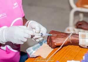 File photo of a health practitioner injecting a patient