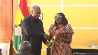 A picture of President Mahama shaking hands with Pamela Graham