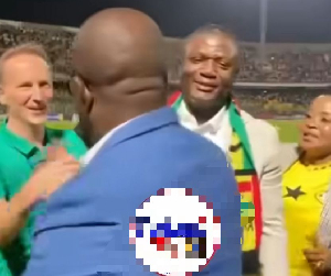 Kurt Okraku (blue) walks past Kofi Adams (white) at the Accra Sports Stadium