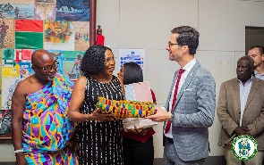 Elizabeth K.T. Sackey presents a Kente cloth to Martin W.W Horn