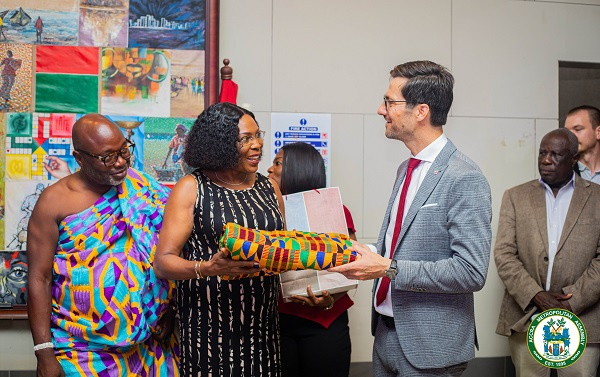 Elizabeth K.T. Sackey presents a Kente cloth to Martin W.W Horn