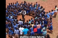 Sackey Percy dances in a circle with his students