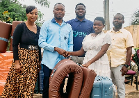 CEO of the OMJ Foundation, presents the scholarship package to one of the beneficiaries