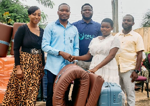 CEO of the OMJ Foundation, presents the scholarship package to one of the beneficiaries