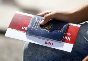 A Migrant Holds His Passport And A Train Ticket In Freilassing, Germany