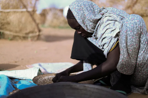 Sudanese mother prepares a meal in Tawila camp