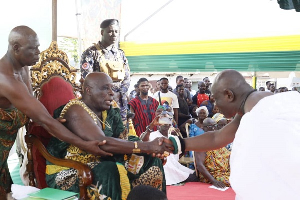 Okyenhene (left) exchanging pleasantries with a chief