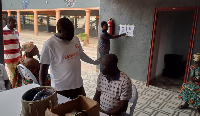 People are seen going through eye screening process