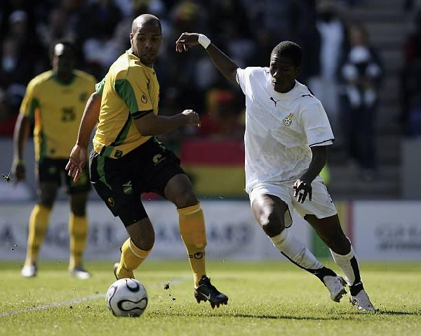 Asamoah Gyan (R) playing against Jamaica in 2006