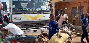 16-year-old Jethro Ongiji with charcoal on a bicycle on Old Mbale Road