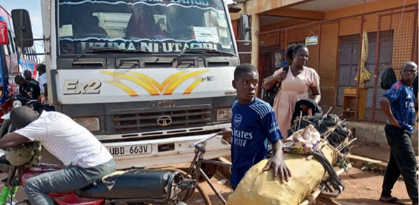 16-year-old Jethro Ongiji with charcoal on a bicycle on Old Mbale Road