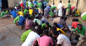 Students of Islamic Senior High School squatting to have meals