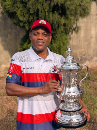 Captain One Golf Society President Mr Appiah with the tournament trophy