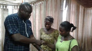 Mr Felix Mensah Nii Annang-La handing the donation to the Kenkey seller