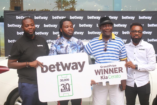 Representatives from Betway Ghana present the keys to Ransford Adika Senanu